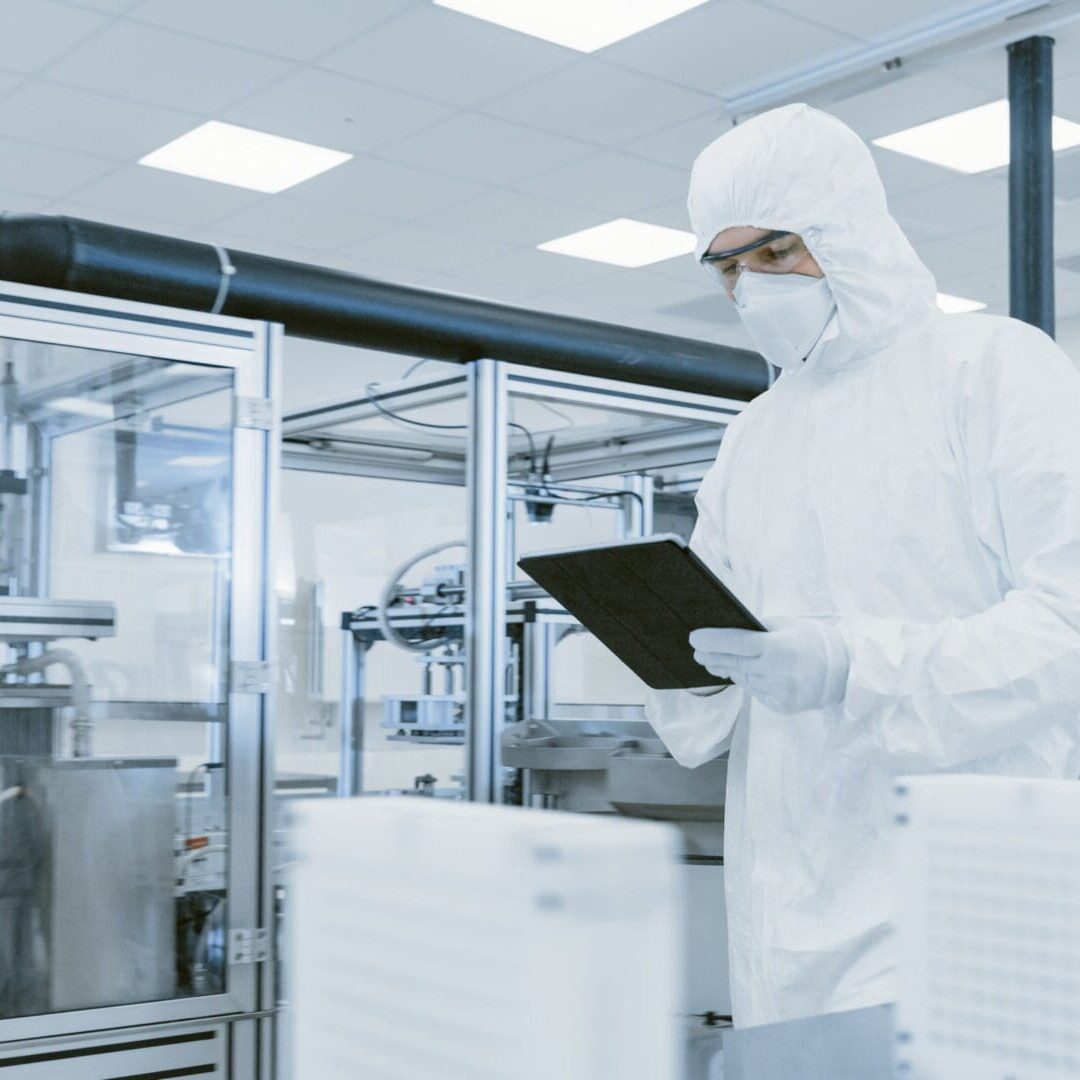 A man in white suit holding a tablet